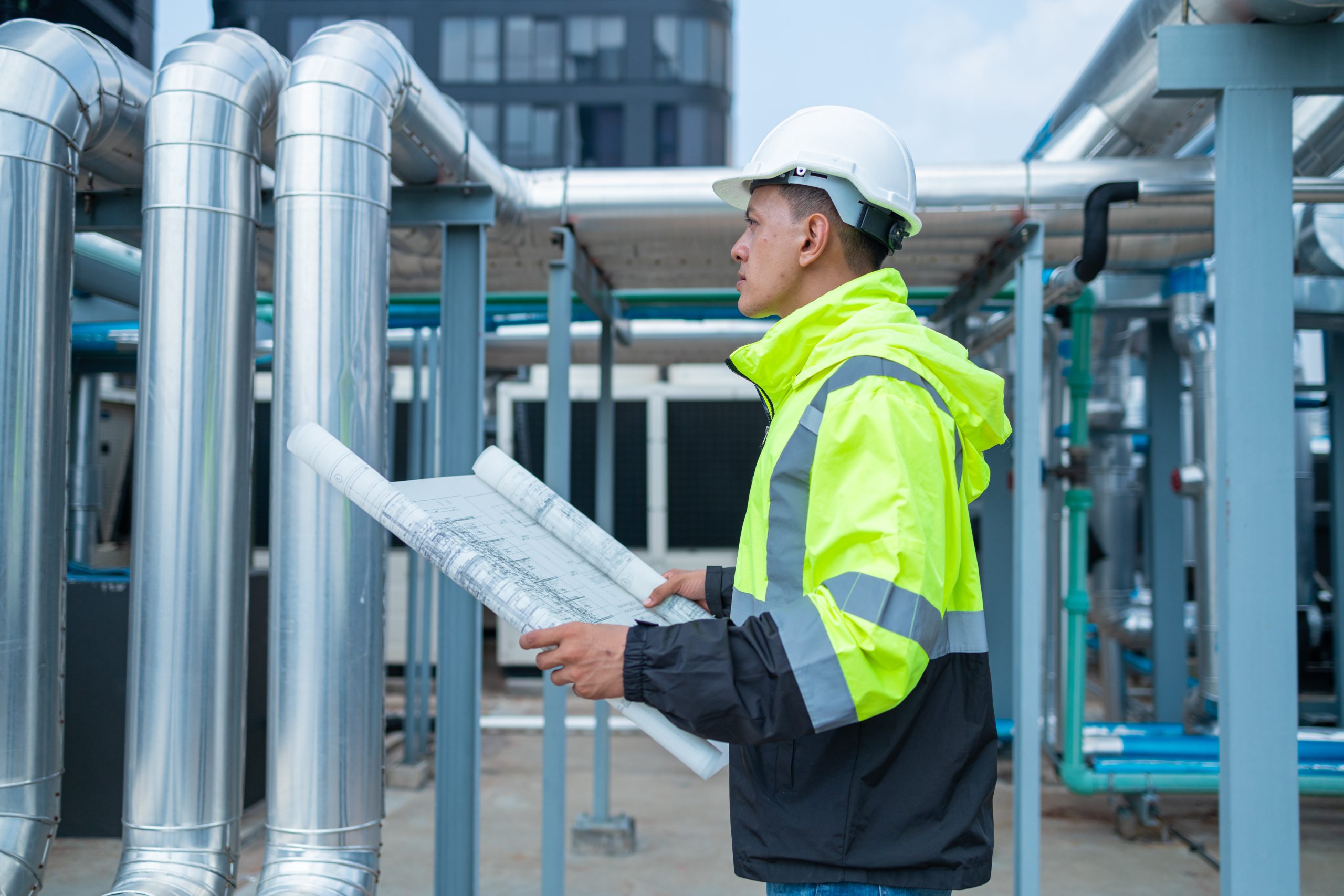 Engineer checking drawings on rooftop